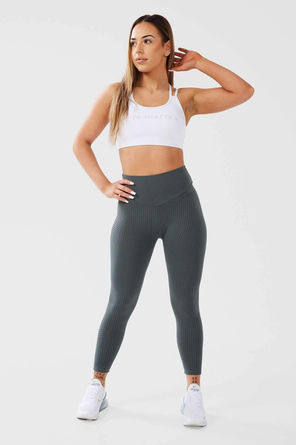 Girl posing wearing khaki luna x seamless scrunch bum leggings front 