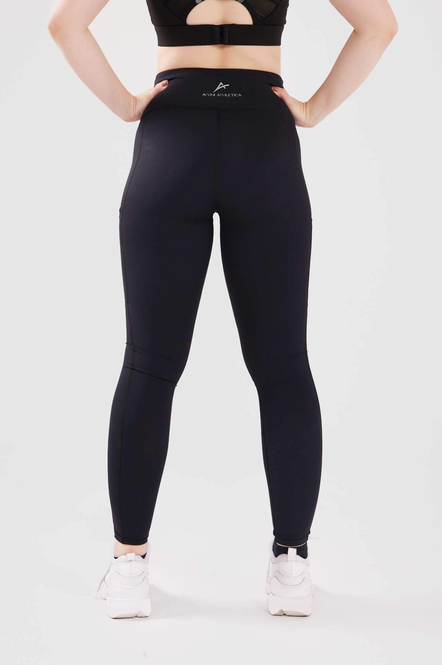 Close up girl posing hands on hips wearing black luxe pocket leggings back 