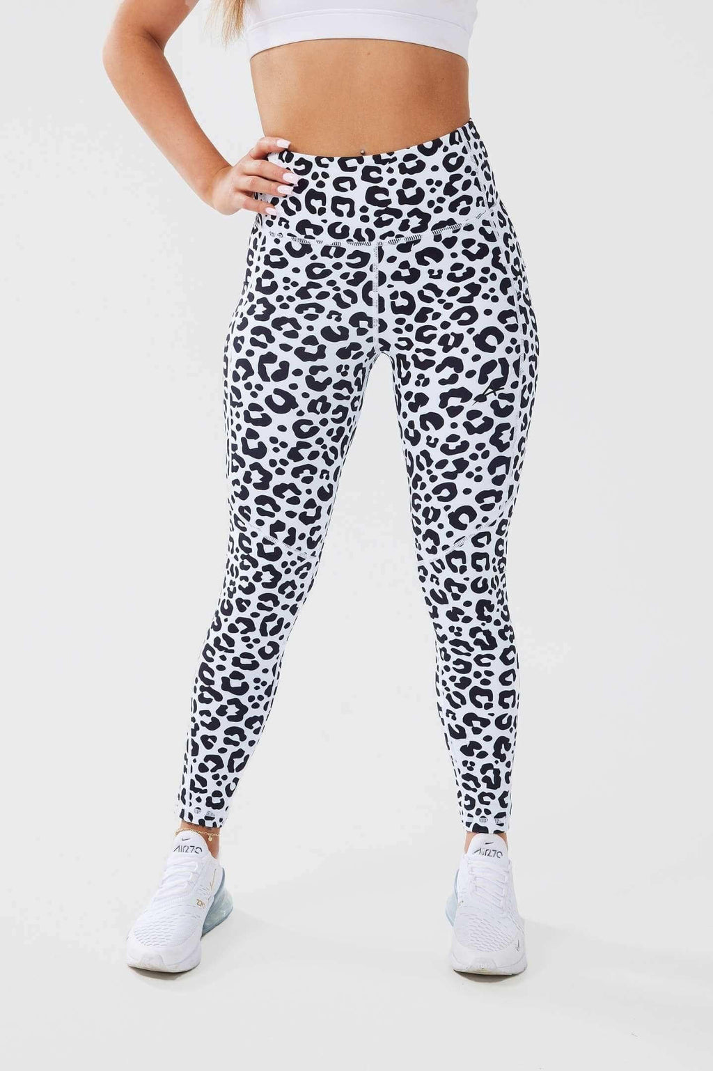 Girl posing hand on hips wearing leopard luxe scrunch bum pocket leggings front