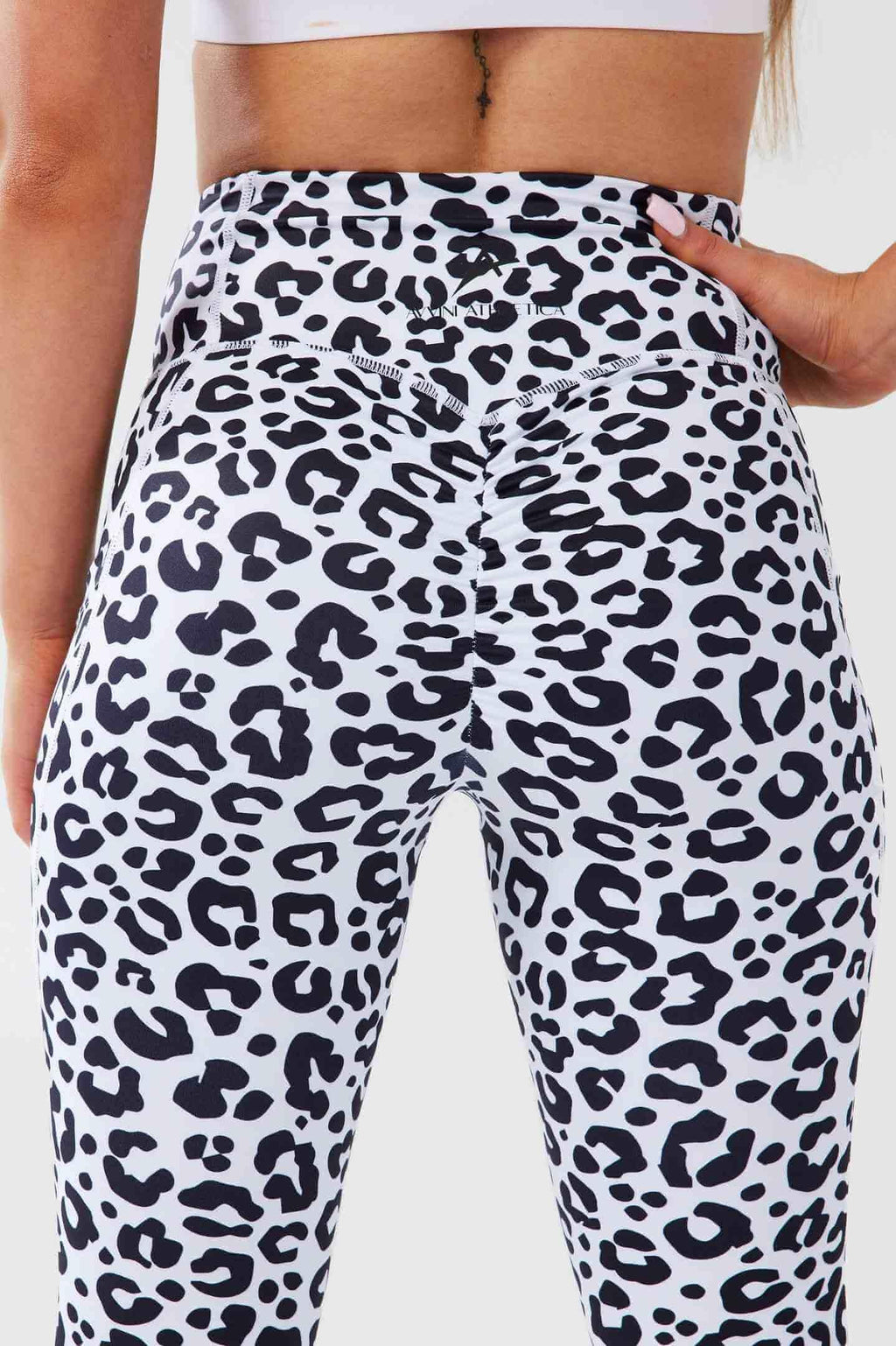 Close up girl posing hand on hip wearing luxe leopard scrunch bum pocket leggings back