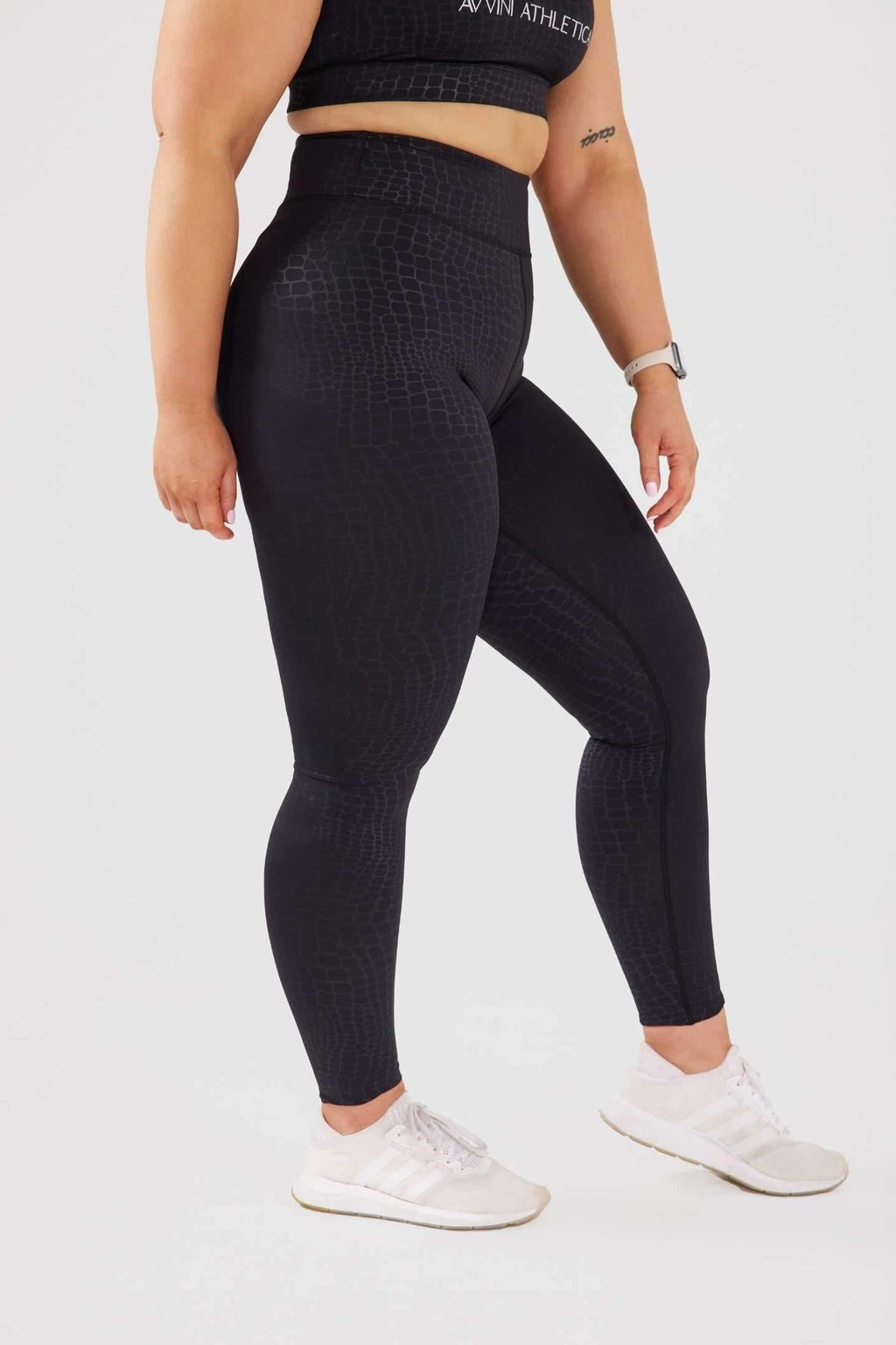 close up girl wearing luxe snake print leggings side 