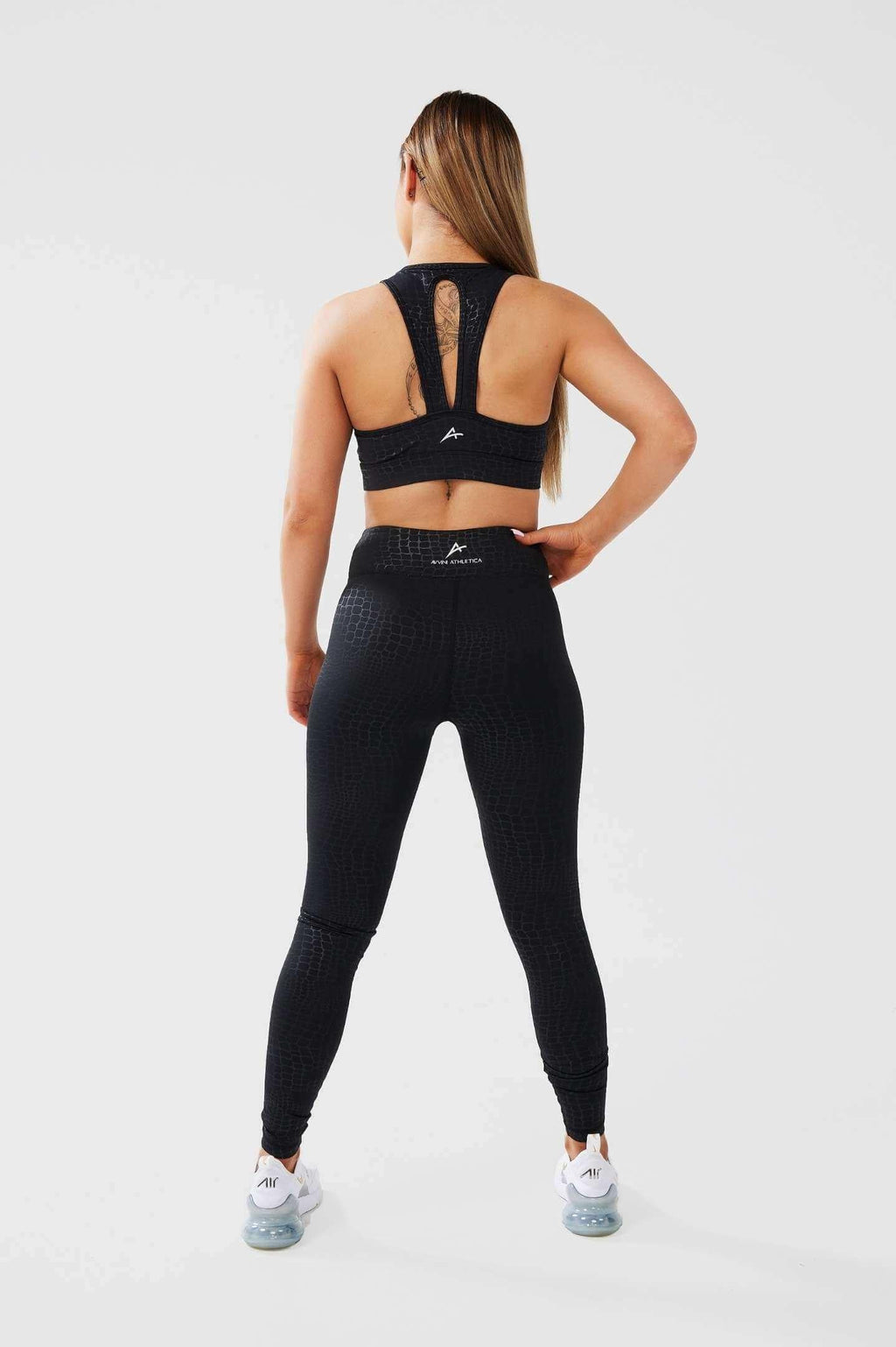 Girl posing hand on hip wearing luxe snake print set back 