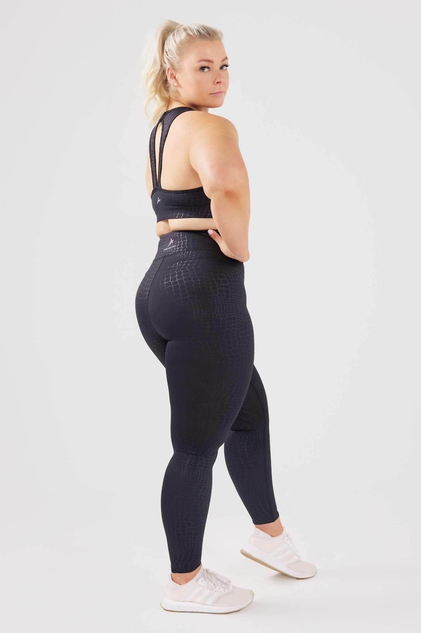 Girl posing hand on hip wearing luxe snake print set side shot