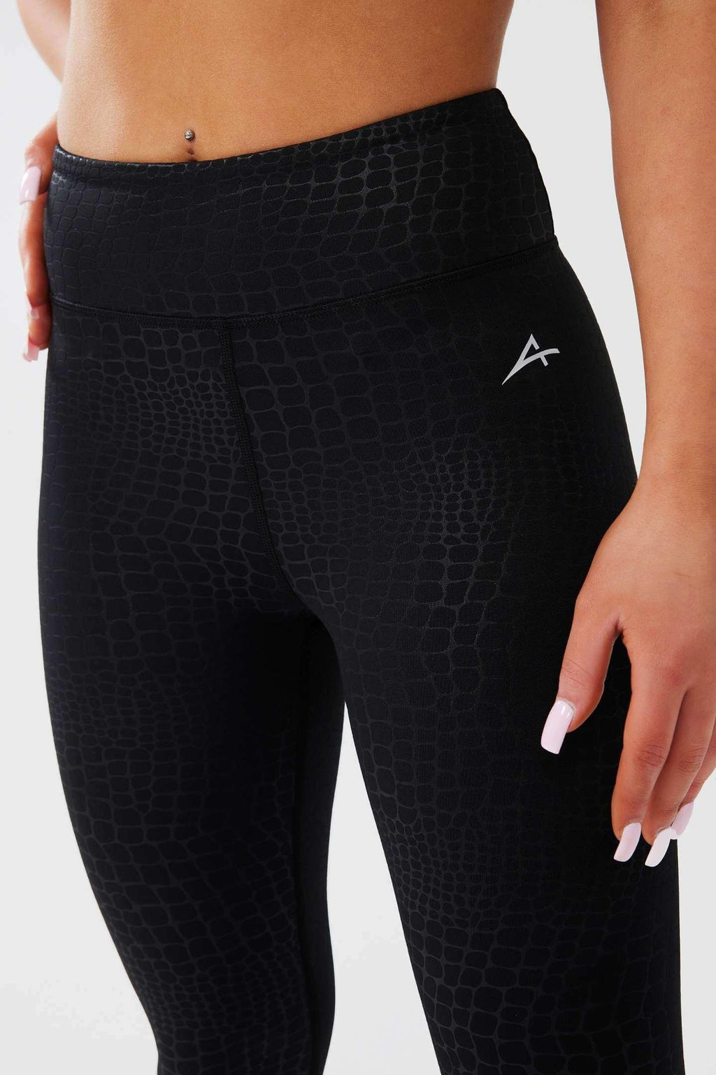 close up girl posing hand on hip wearing luxe snake print leggings side 