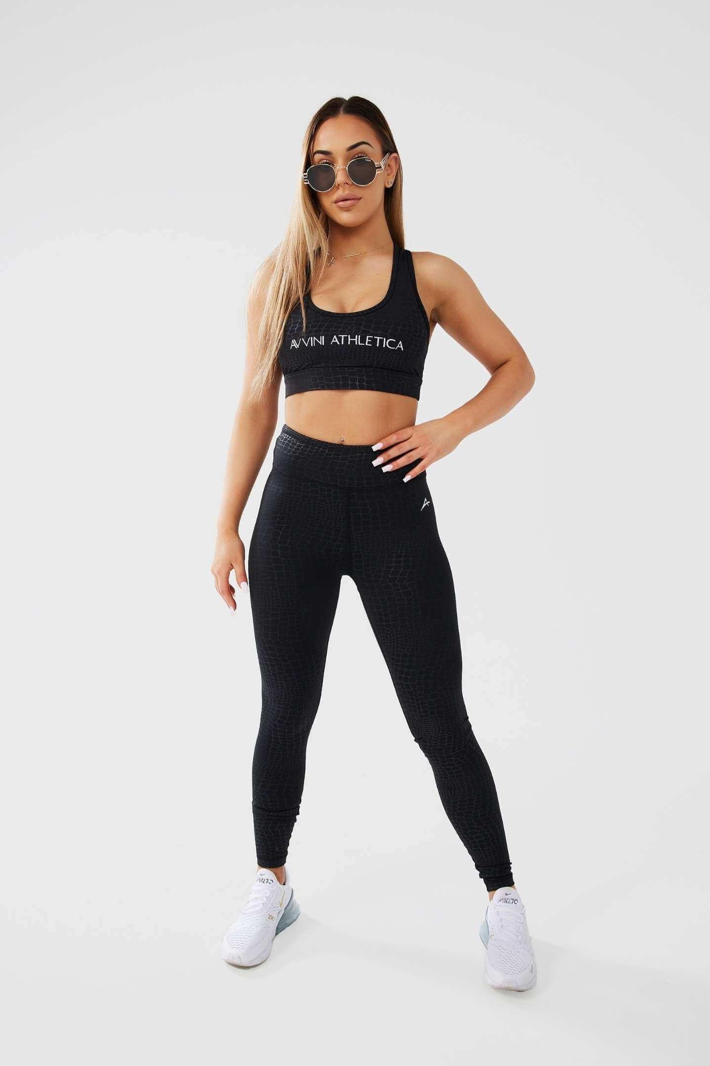 Girl wearing sunglasses posing hand on hip wearing luxe snake print set