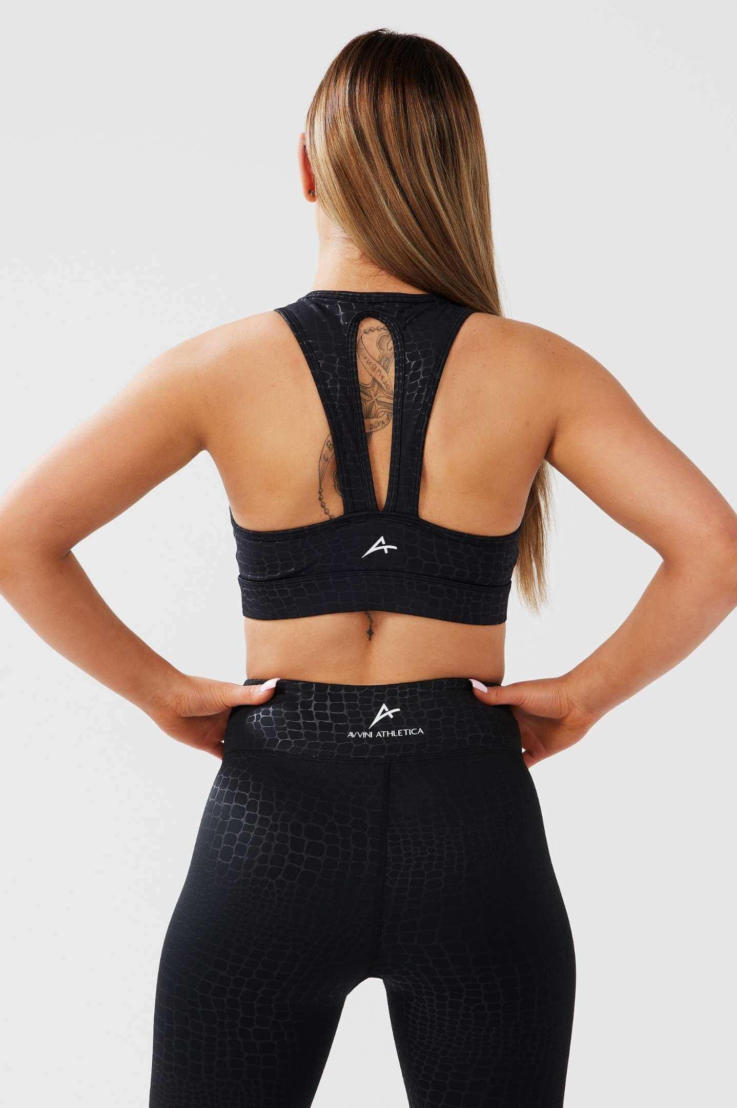 Girl posing hands on hips wearing luxe snake print set back