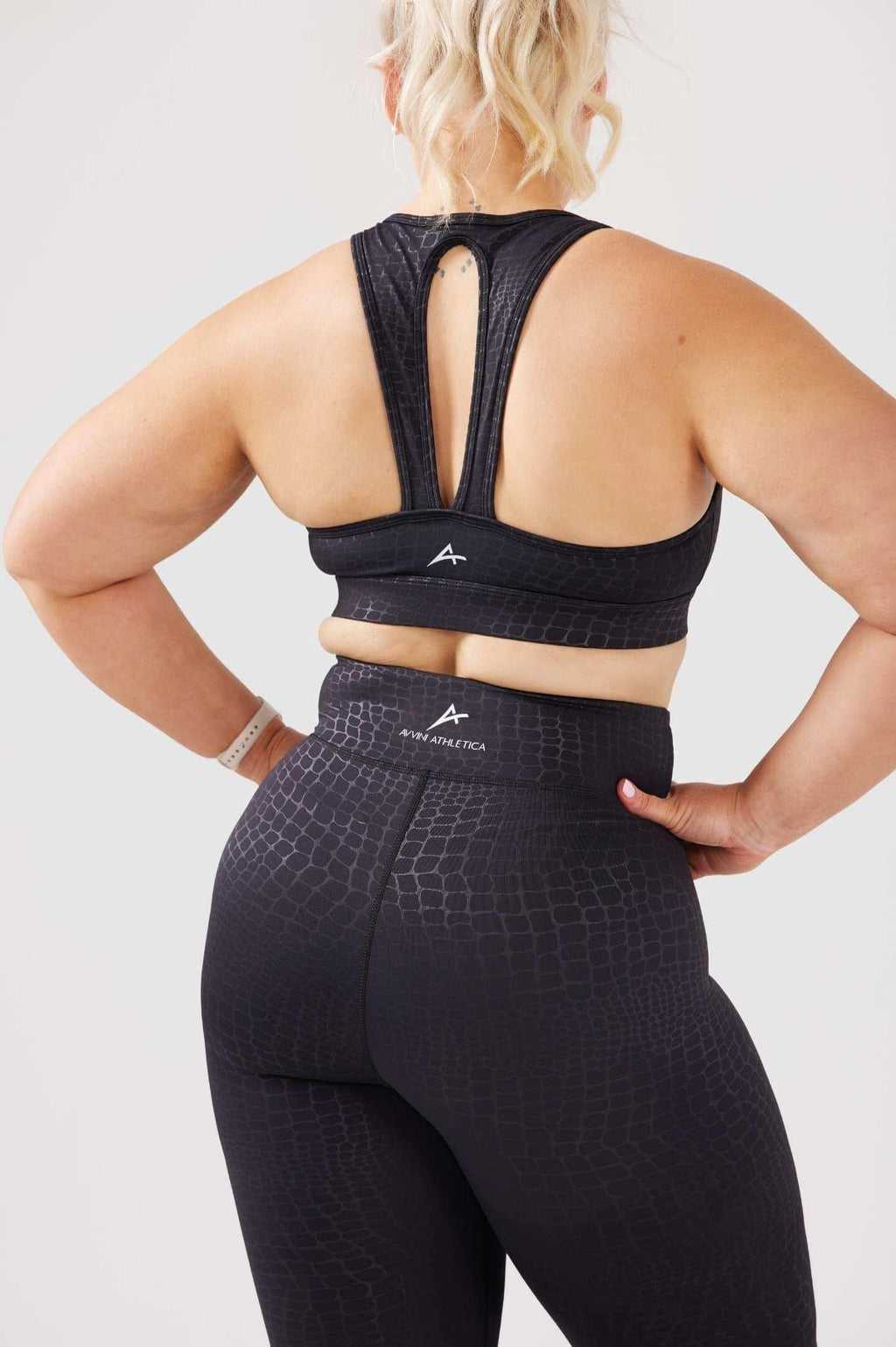 Girl posing hands on hips wearing luxe snake print crop top back